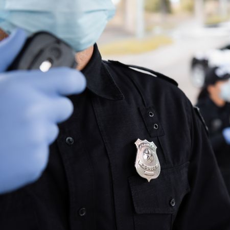 Officer wearing protective medical gloves